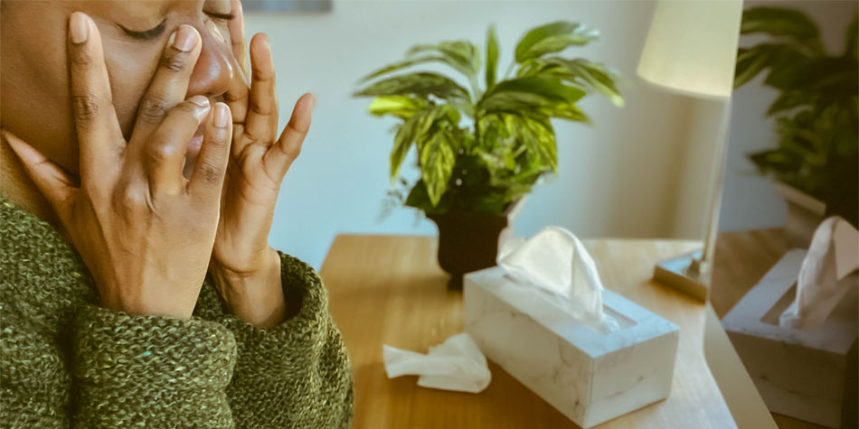 a person rubbing their face because they are suffering from allergies