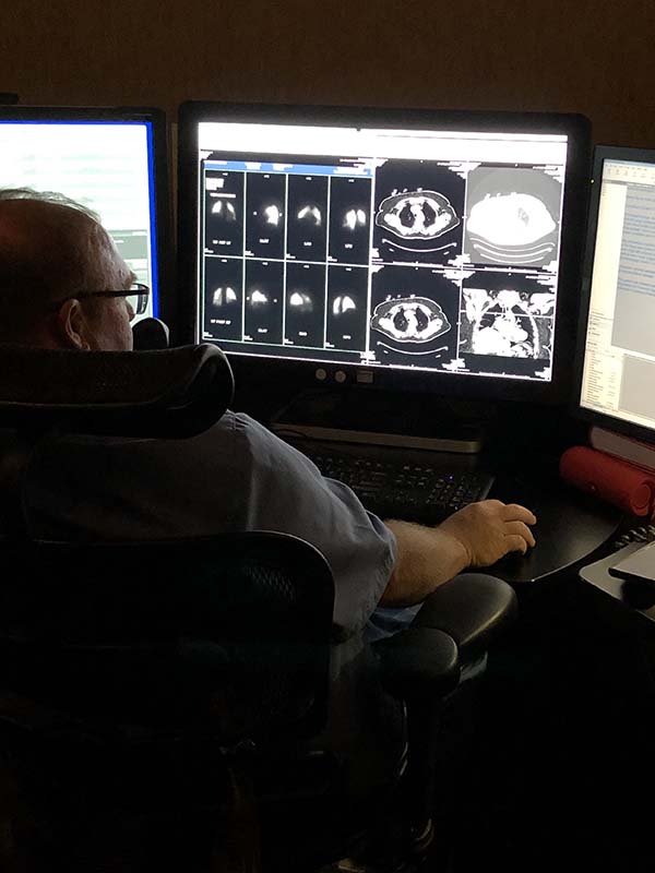 Man sitting and looking at brain x-ray