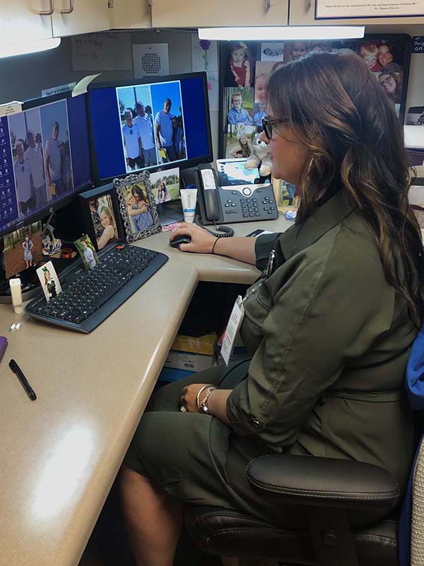 Tracy Brinley working on a computer in her office