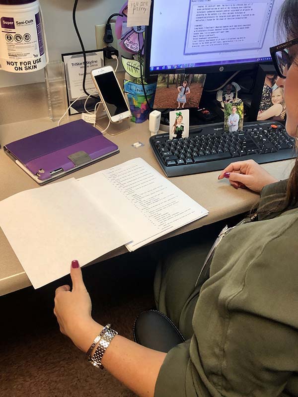 Hand examining a lung scan report