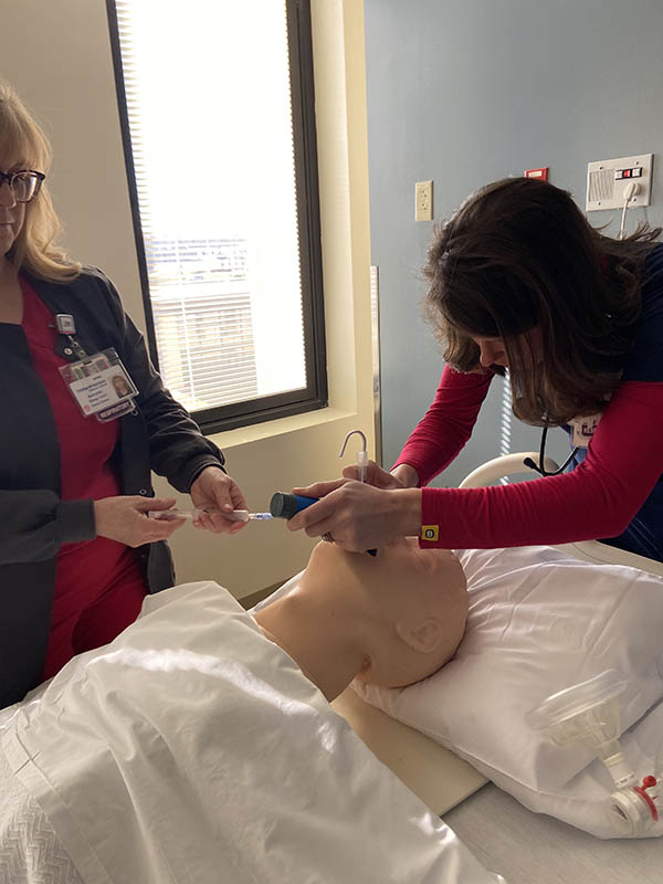 Lindsey and Annette continue the intubation process on a dummy